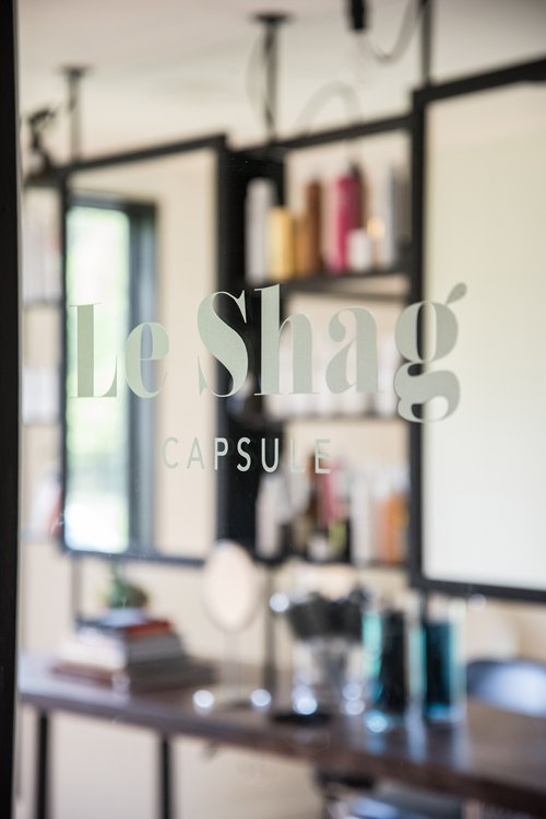 A blurred image of a le shag capsule store