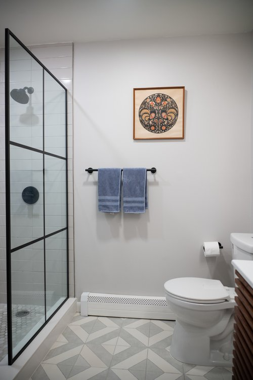 A bathroom with a toilet and a shower stall