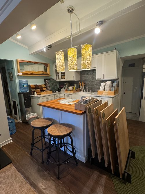 A kitchen with a wooden island and stools