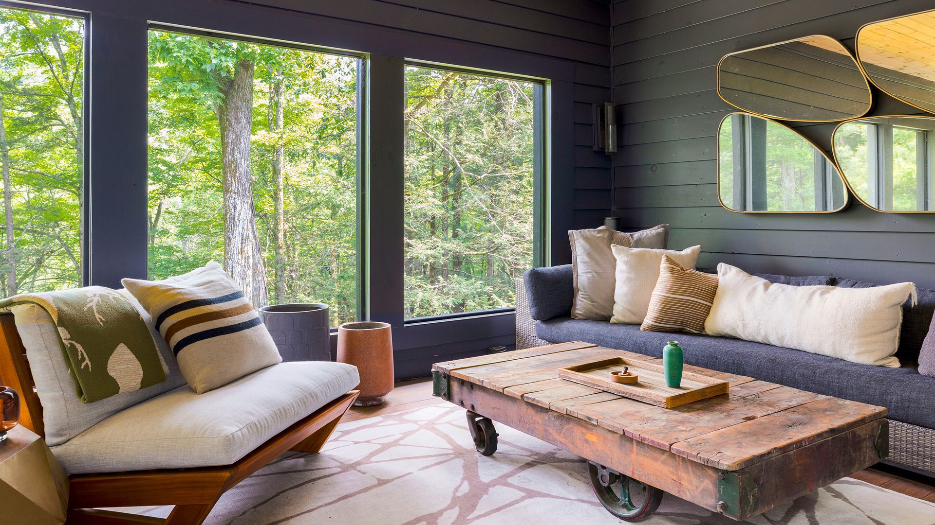 A cozy living room with a dark-paneled wall
