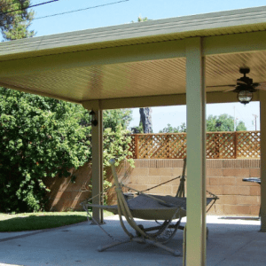 A patio with a hammock and a ceiling fan