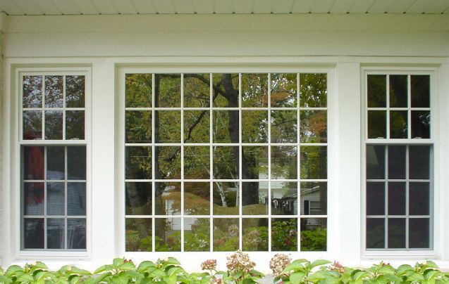 A white window with a lot of windows on a house.