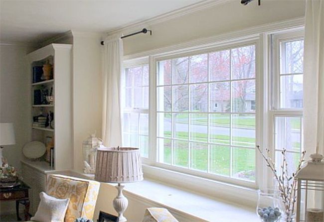 A living room with a large window and a couch.