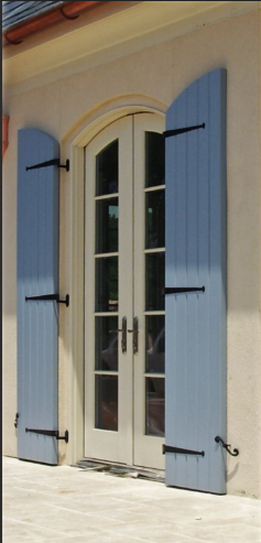 A white door with blue shutters on it