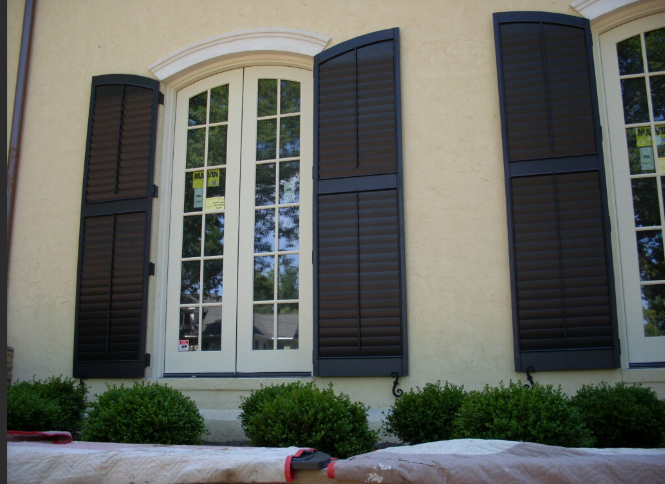 A house with arched windows and black shutters