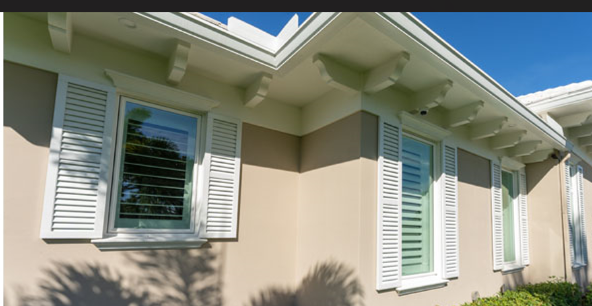 A house with a lot of windows and shutters on it