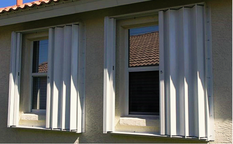 A house with white shutters on the windows