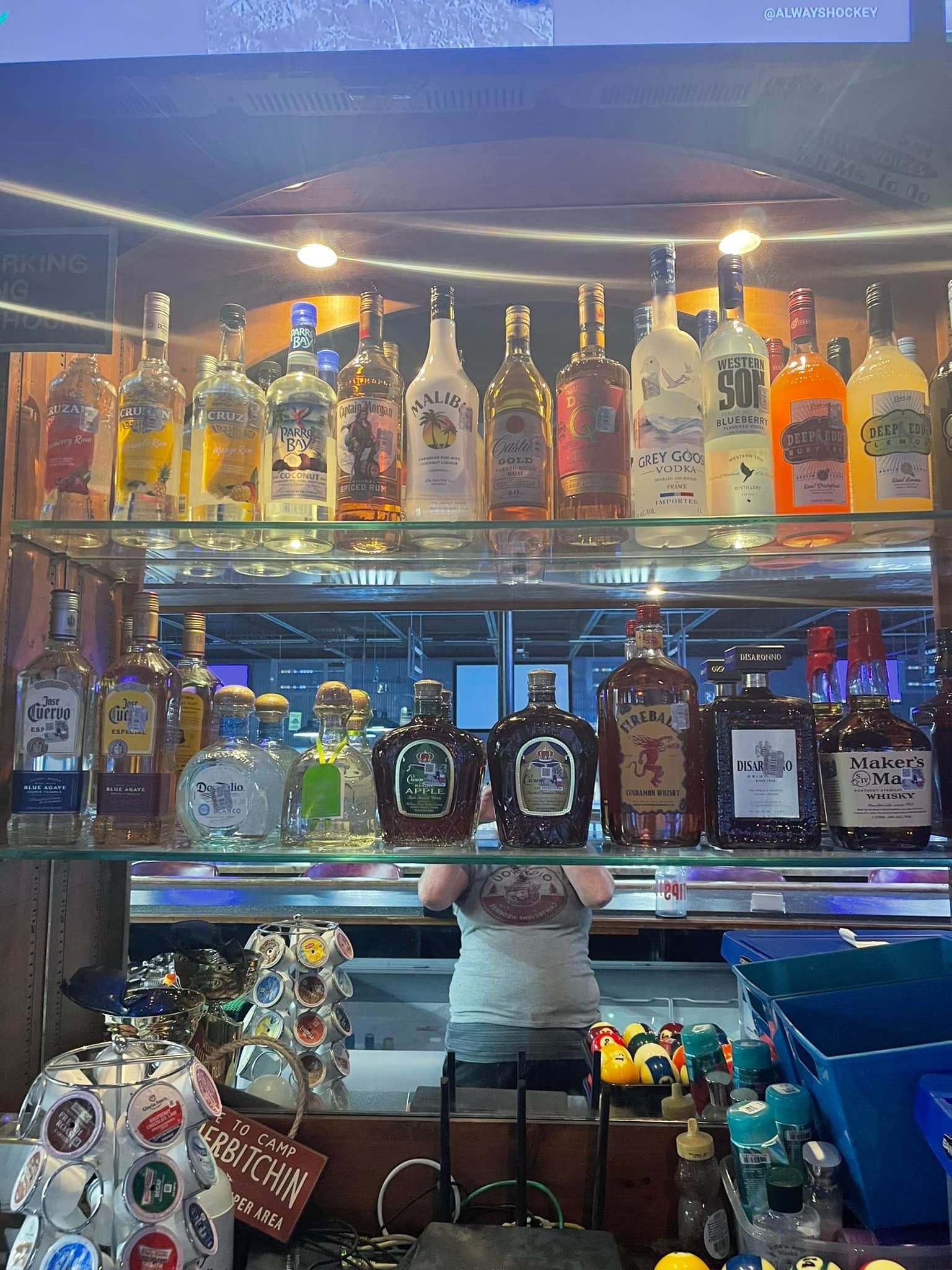 A bar filled with lots of liquor bottles on shelves.