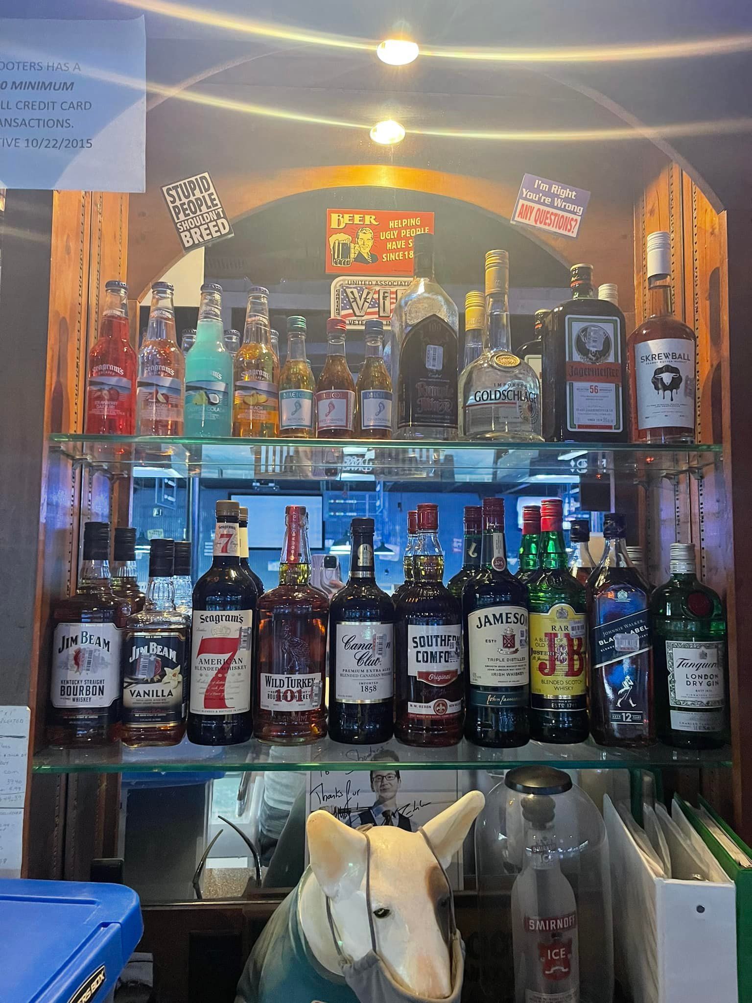A shelf filled with bottles of liquor.