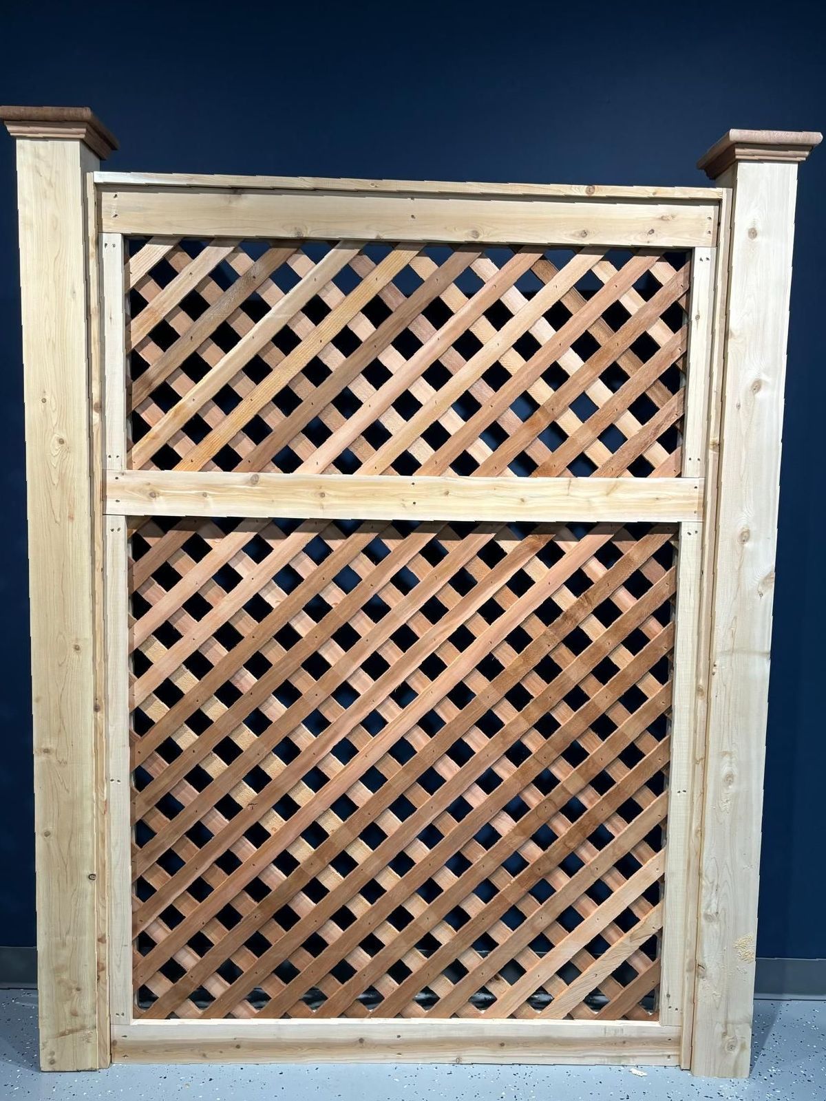 A wooden lattice fence with a blue background