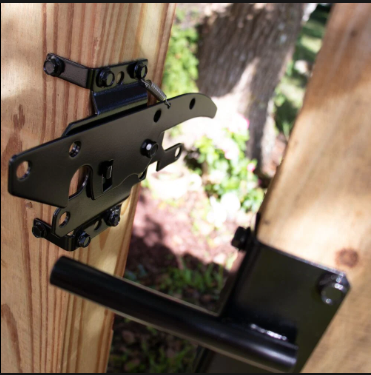 A wooden fence with a black latch attached to it