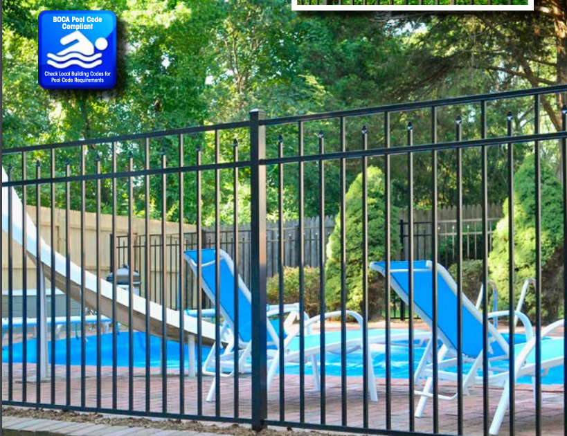 A fence surrounds a swimming pool with a sign that says no diving