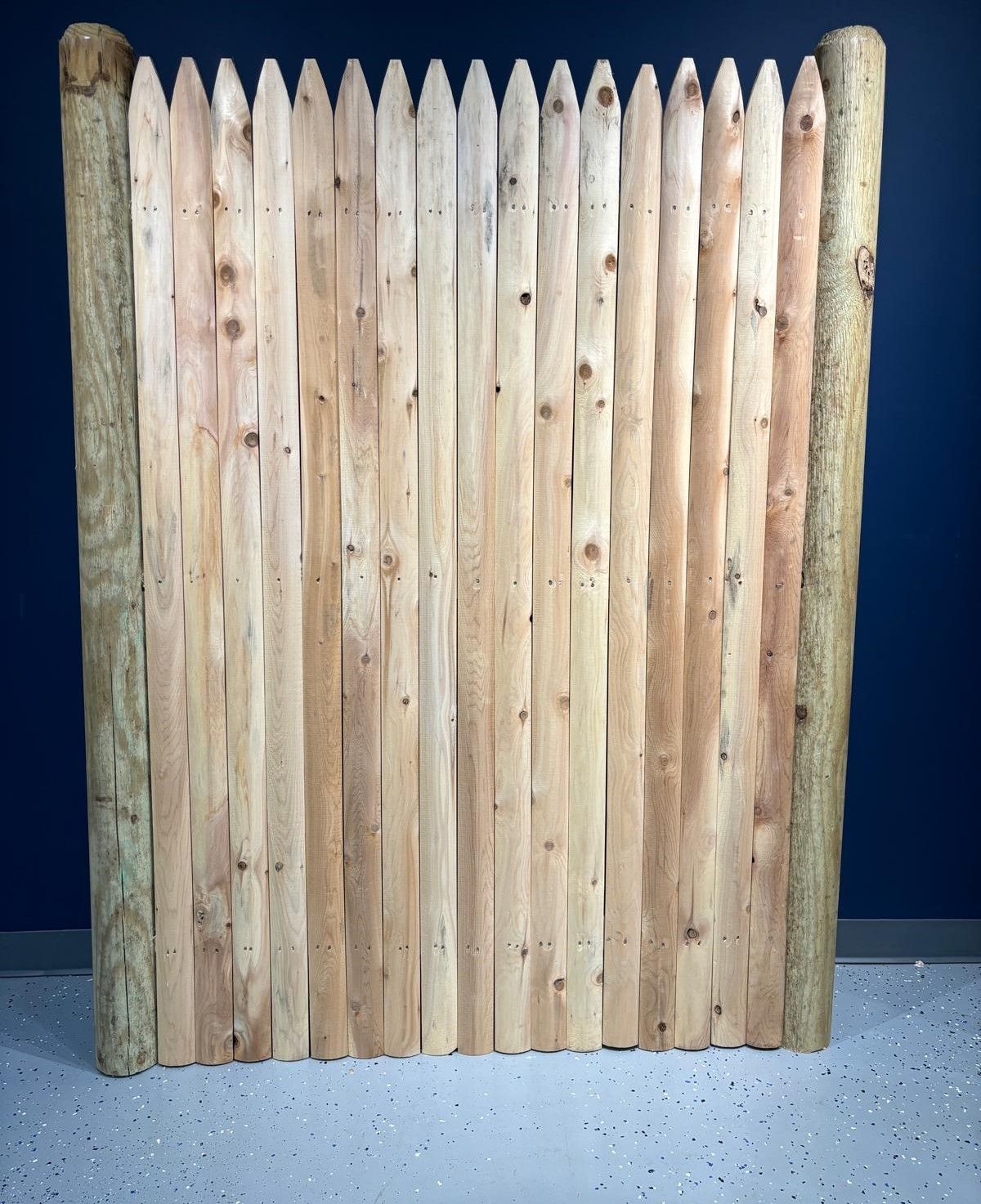 A wooden fence is sitting on a concrete floor