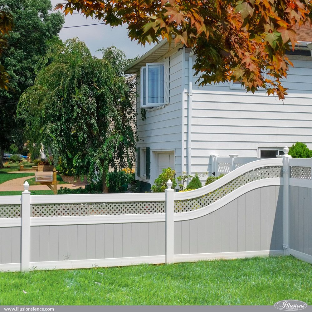 A white house with a white fence in front of it