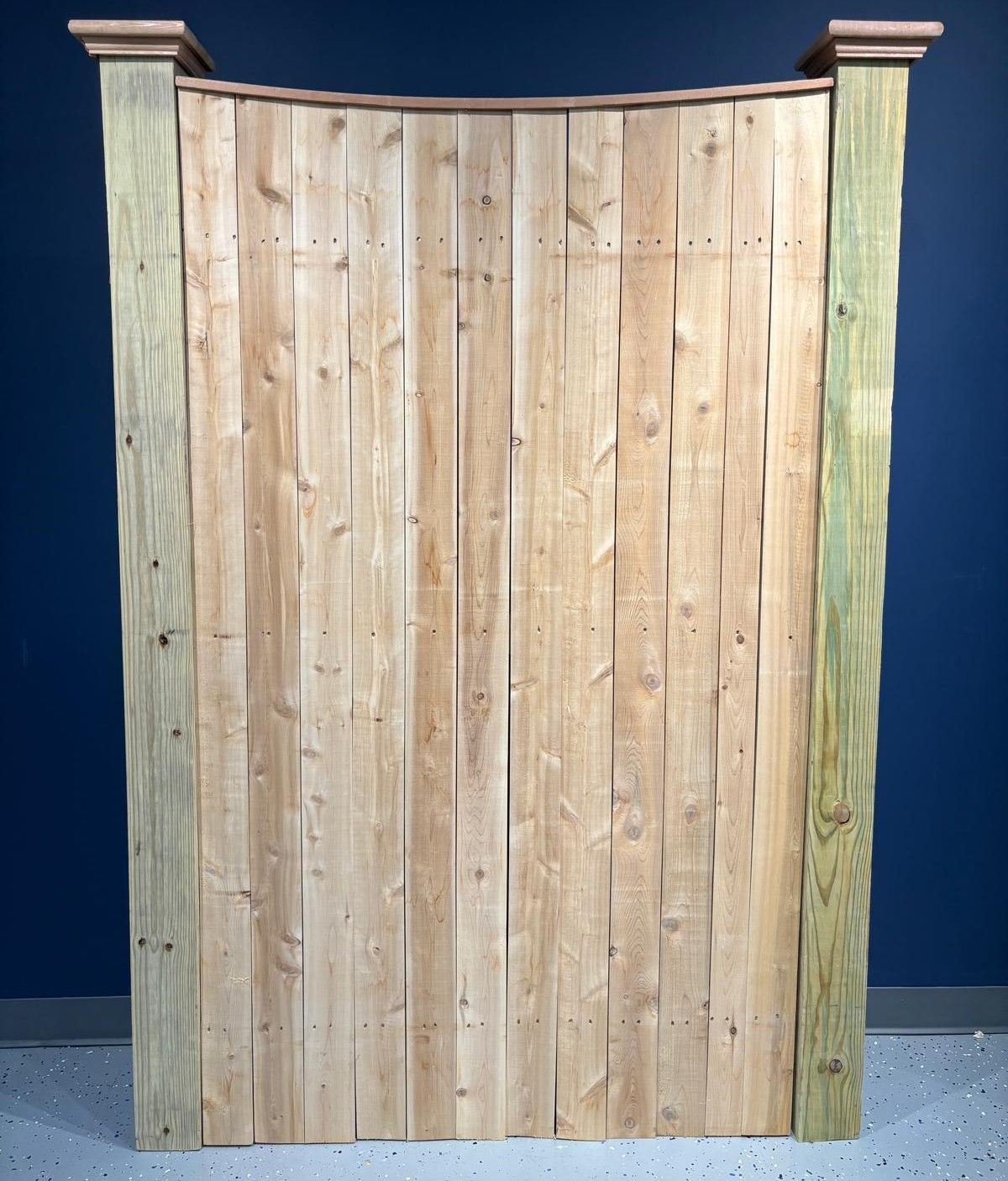 A wooden fence with a blue wall in the background