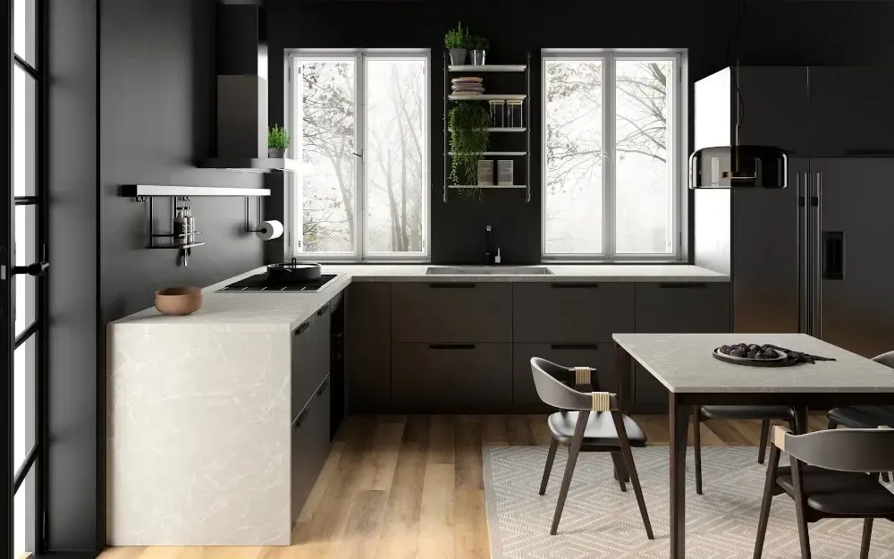 Modern black and white kitchen with a window view of snowy trees and a dining table.