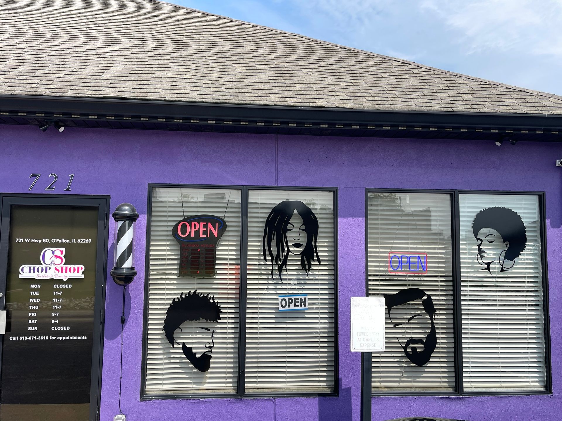 Purple-painted barbershop with a spinning barber pole, 