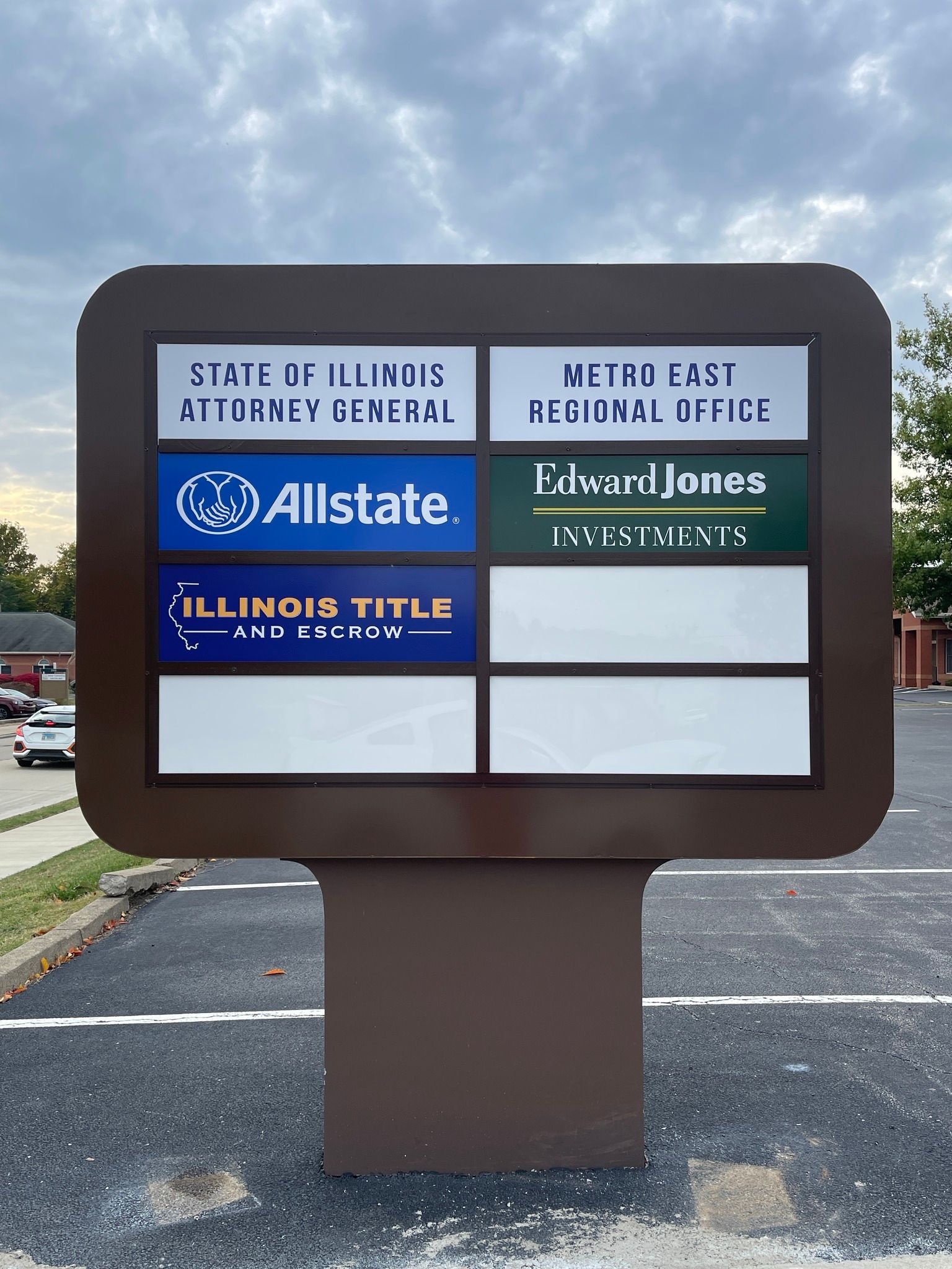 Sign with company names: State of Illinois, Allstate, Illinois Title, Metro East, Edward Jones. Brown and white.