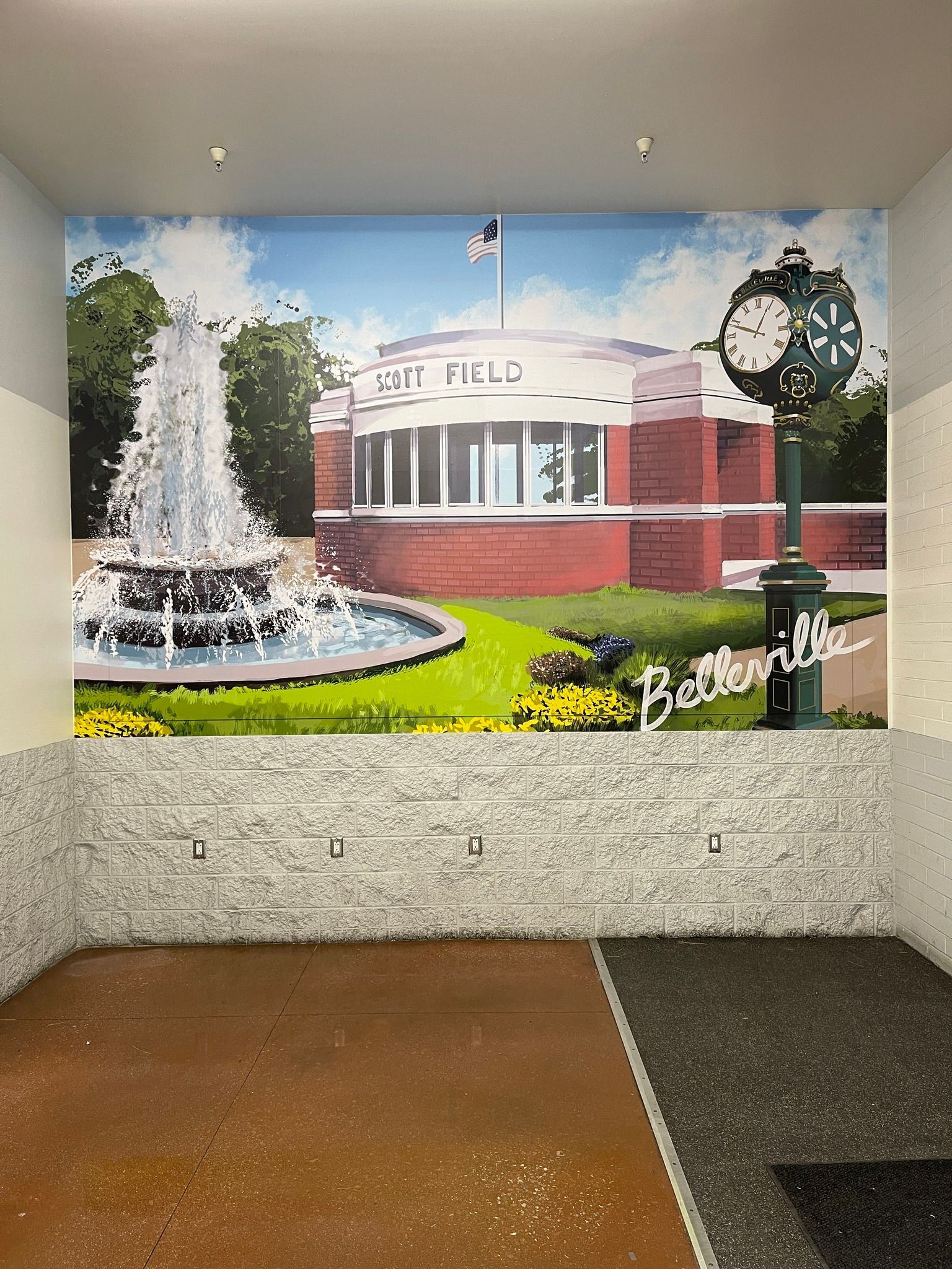 Mural depicting Belleville City Hall with a fountain, clock, and blue sky.