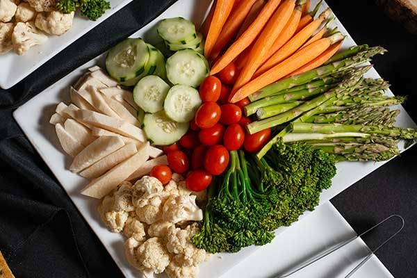 A white plate topped with a variety of vegetables.