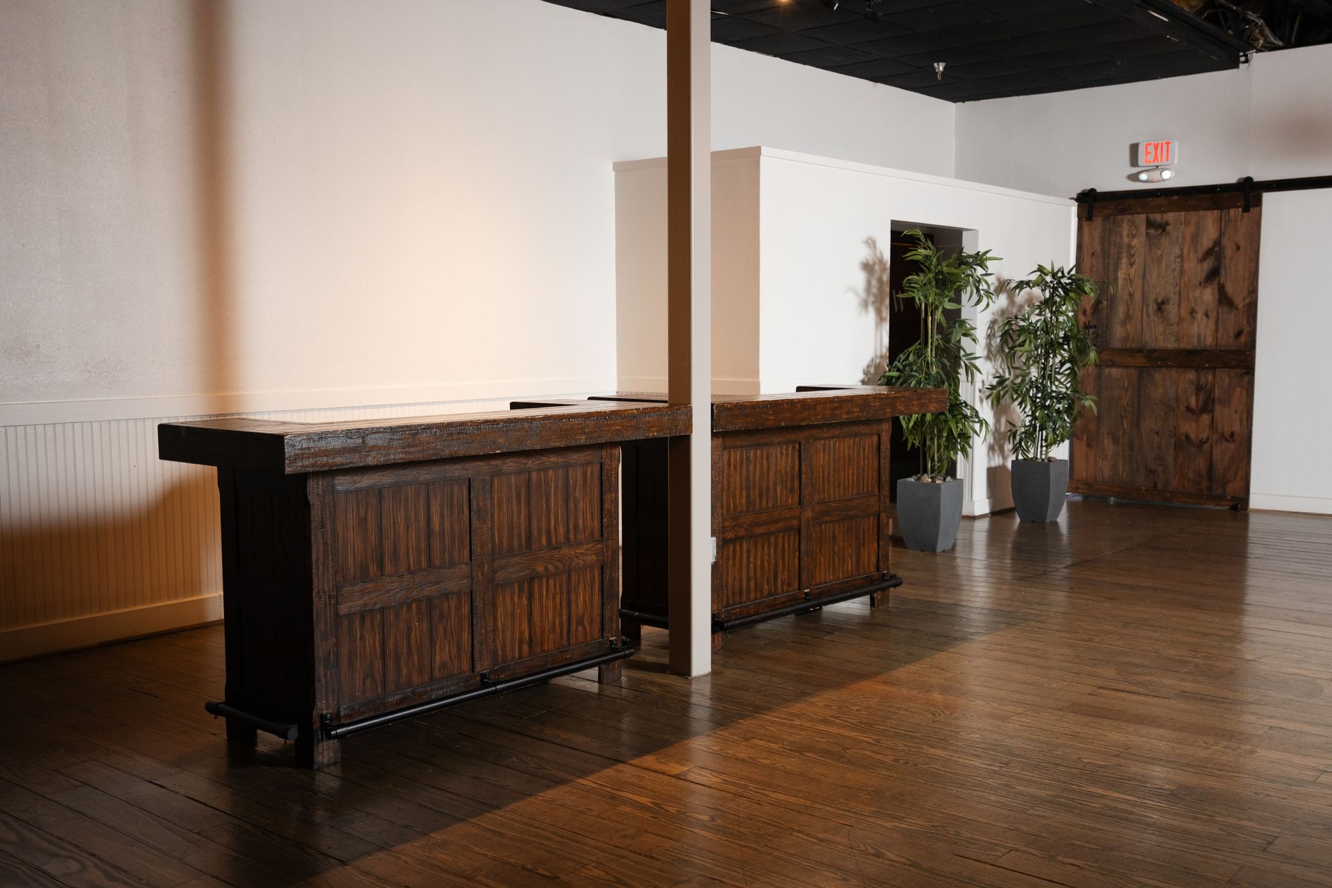 There are two wooden tables in the middle of the room.