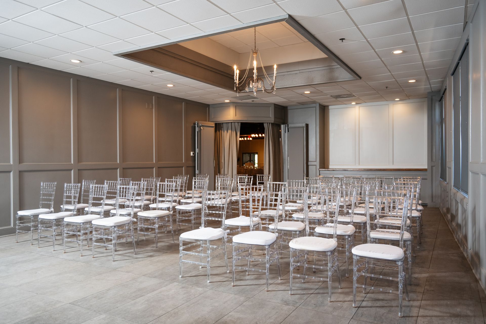 A large room with rows of chairs and a projector screen.