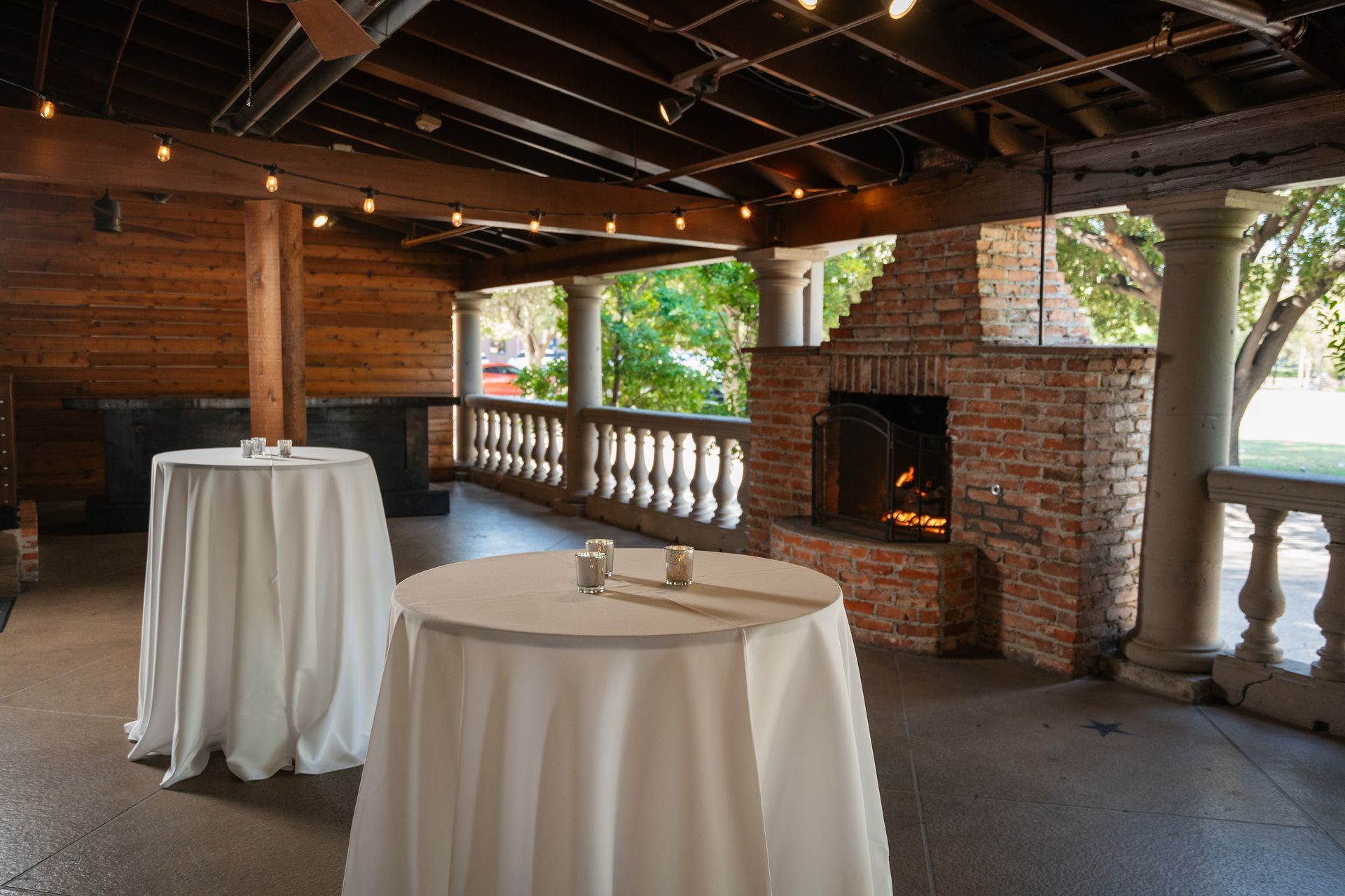 A room with tables and a fireplace in it.