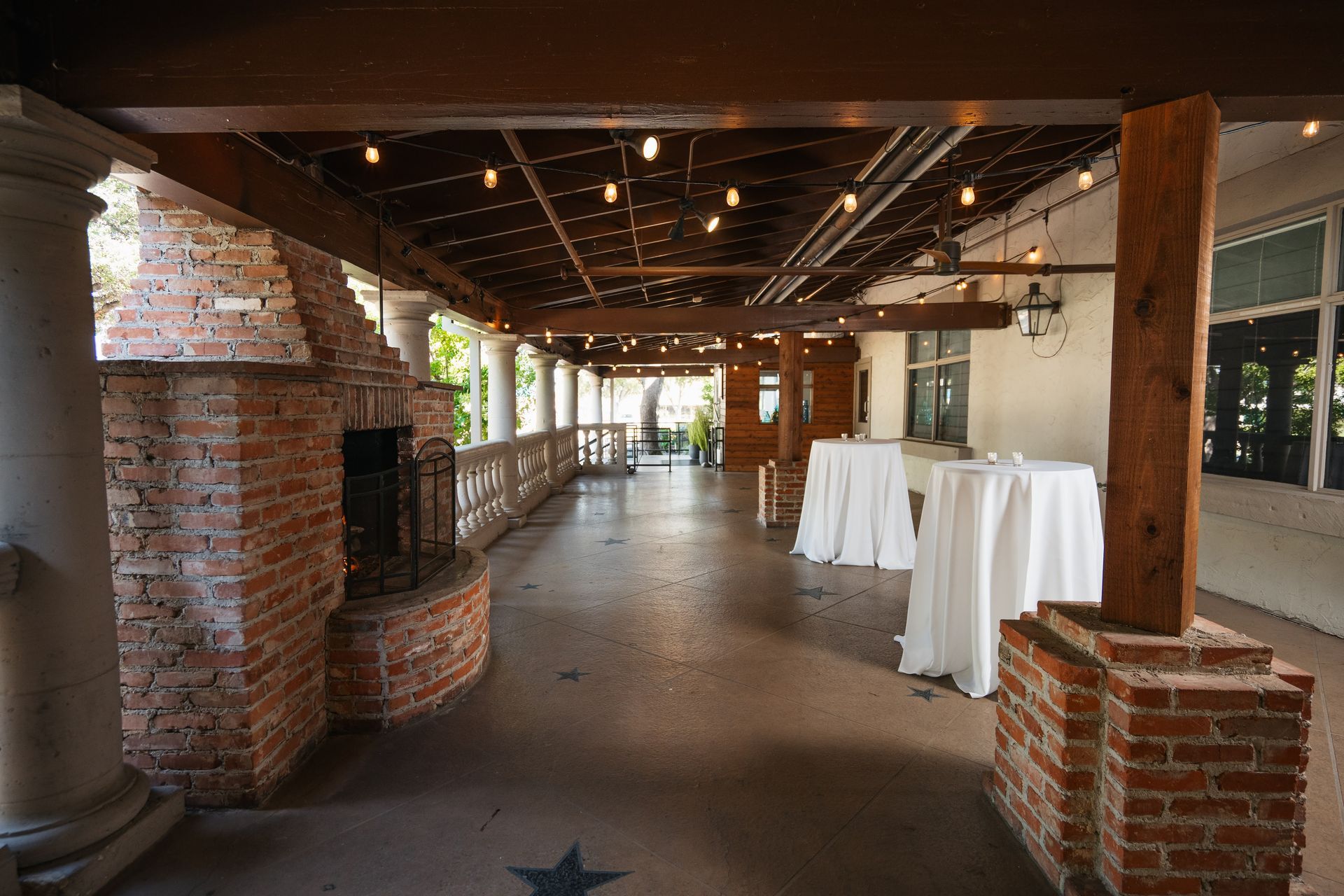 There is a brick fireplace in the middle of the room.
