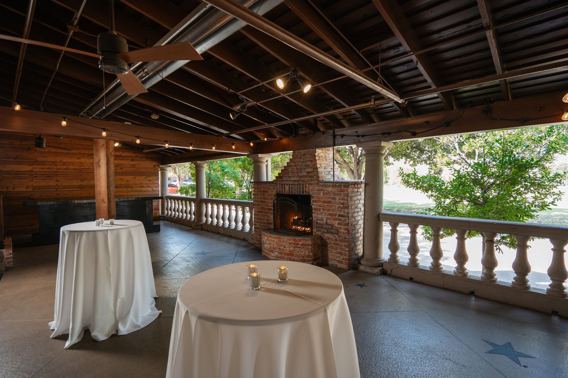A room with tables and a fireplace in it.