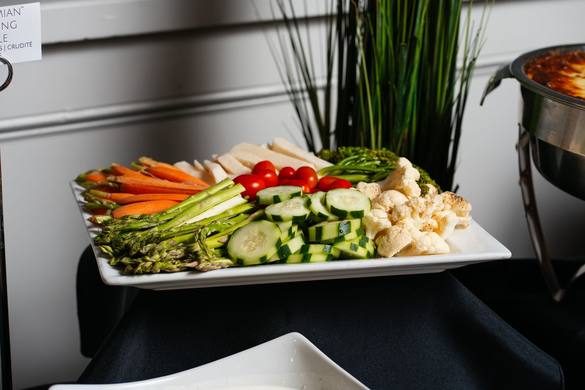A white plate topped with a variety of vegetables on a table.