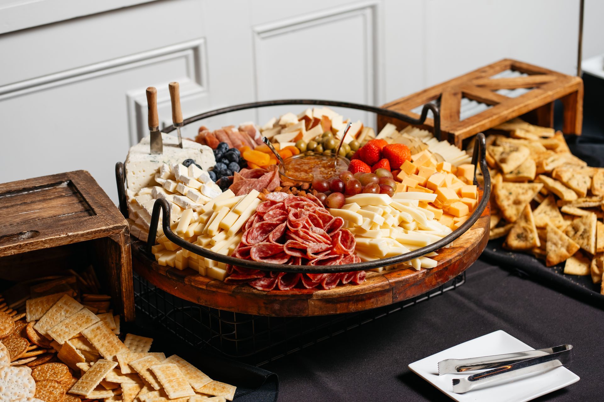 There is a tray of cheese and crackers on the table.