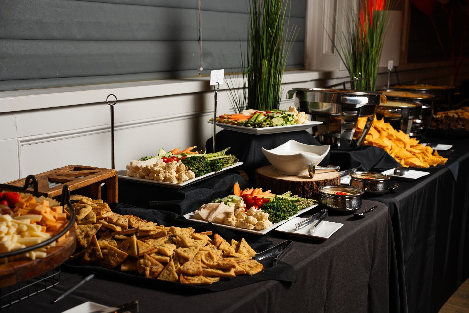 A buffet table with a variety of food on it.