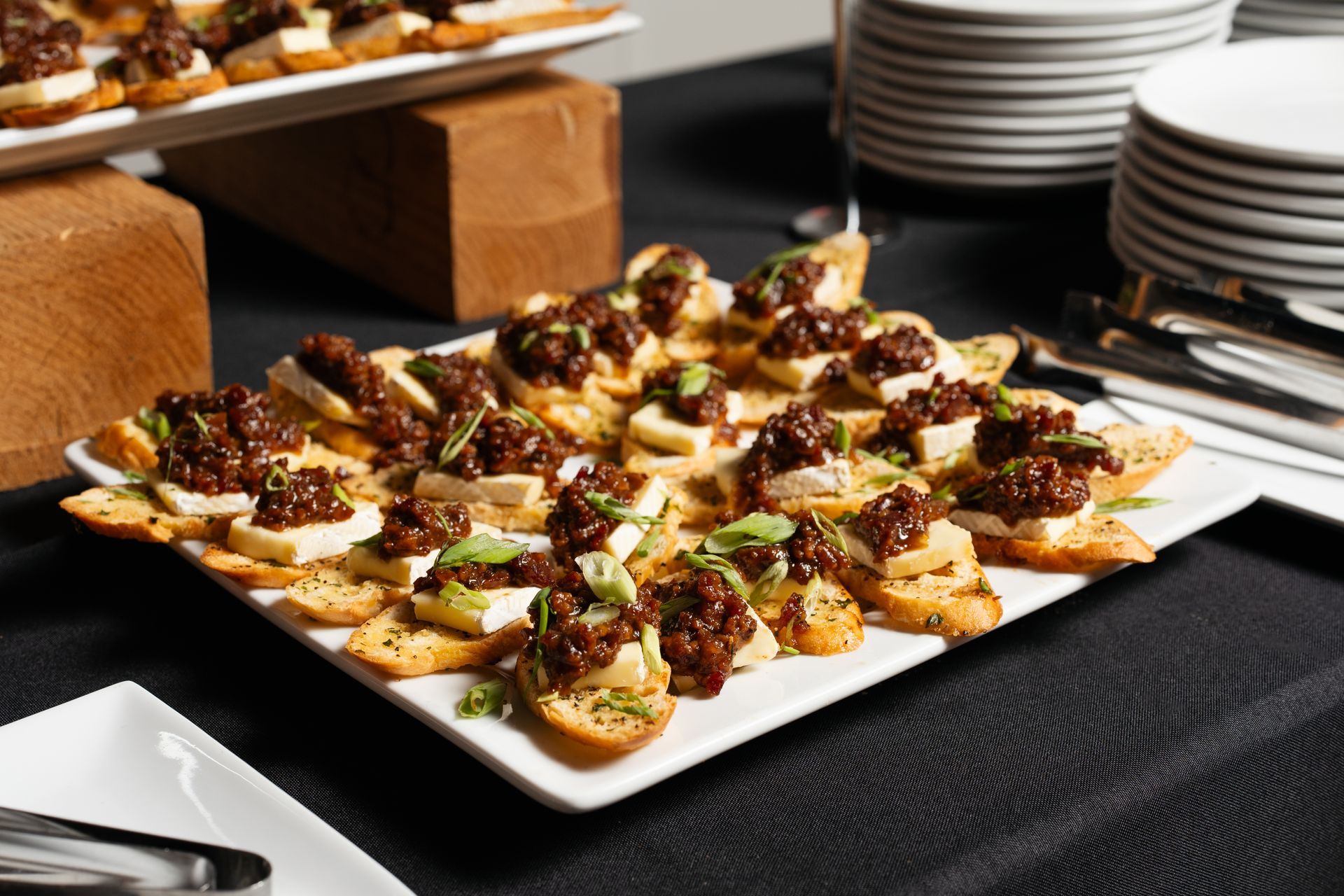 A white plate topped with a variety of appetizers on a table.