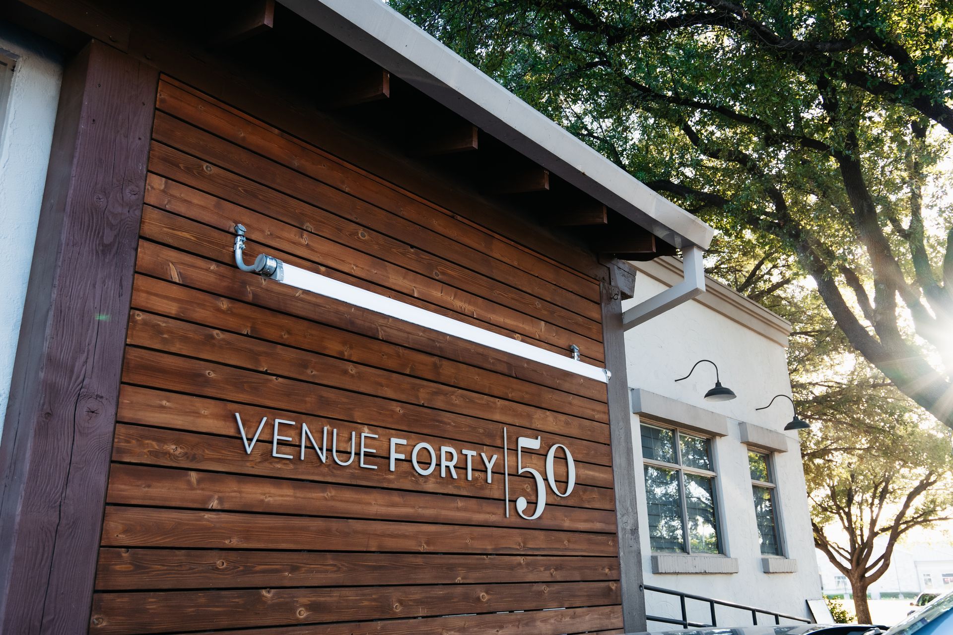 A wooden building with a sign that says venue forty 50