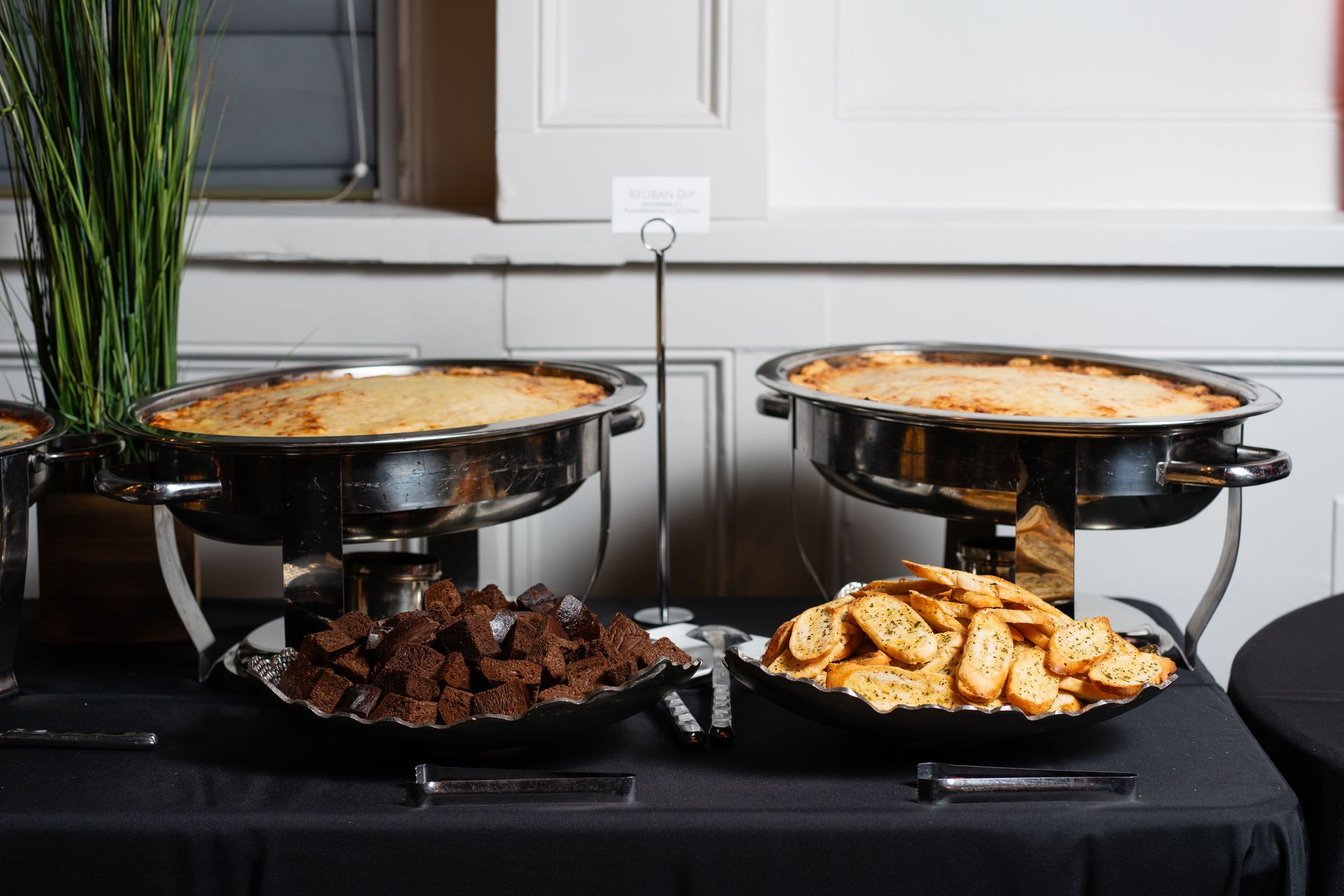 A buffet table with a variety of food on it.