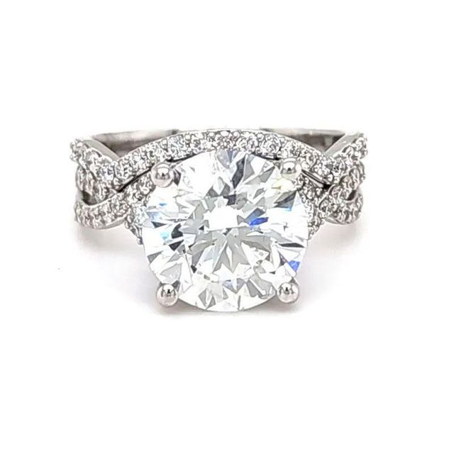Diamond engagement ring with large round center stone and pavé-set band on white background