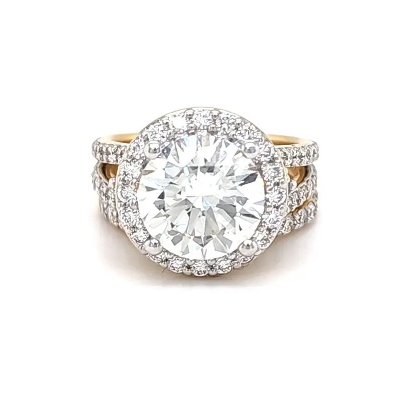 Gold ring with a large round diamond and halo of smaller diamonds