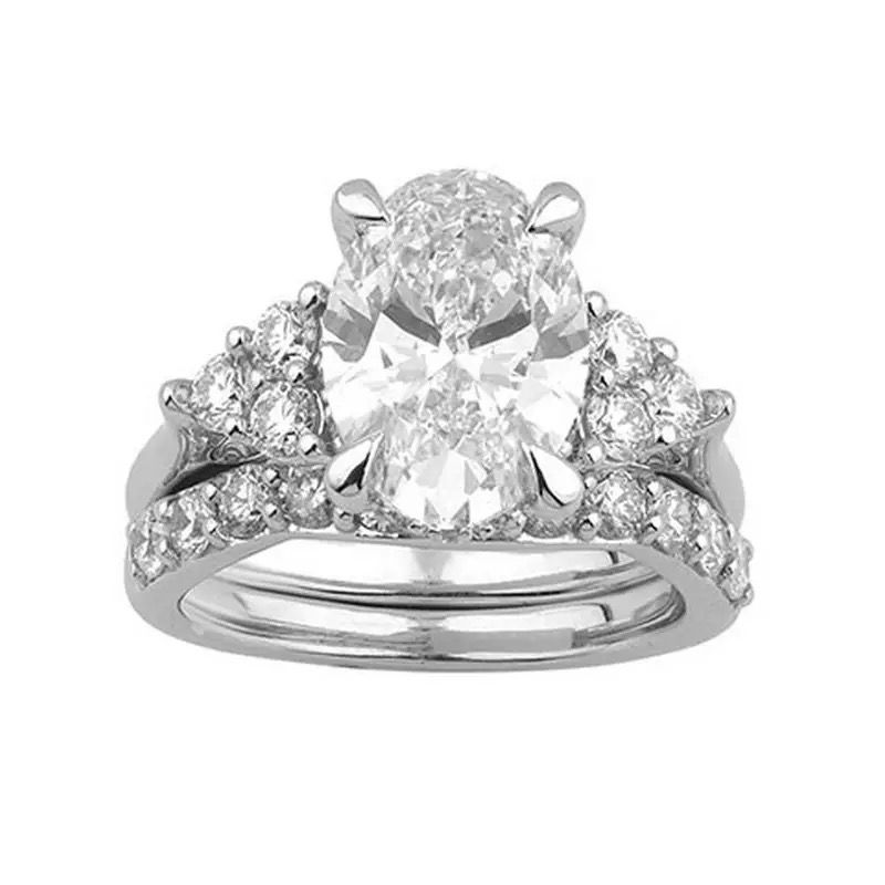 Diamond engagement ring with a large center stone and two side stones on a white background