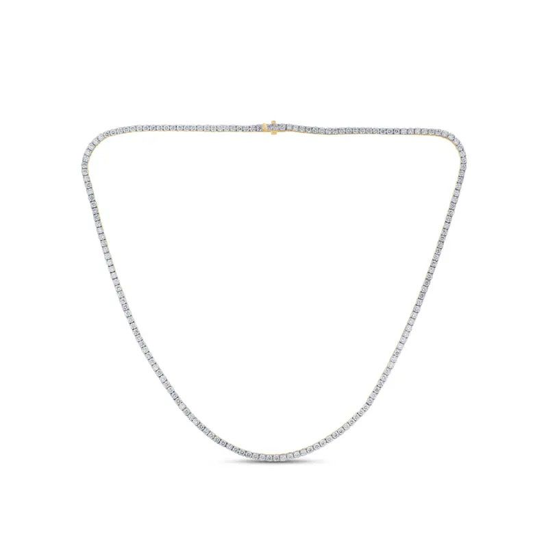 Delicate silver necklace laid in a U-shape on a white background