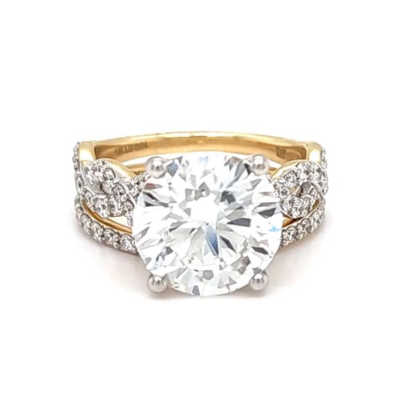 Gold ring with a large round diamond and pave-set side stones
