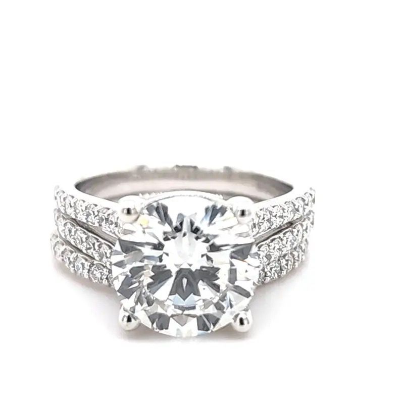 Diamond halo engagement ring with split shank band on white background