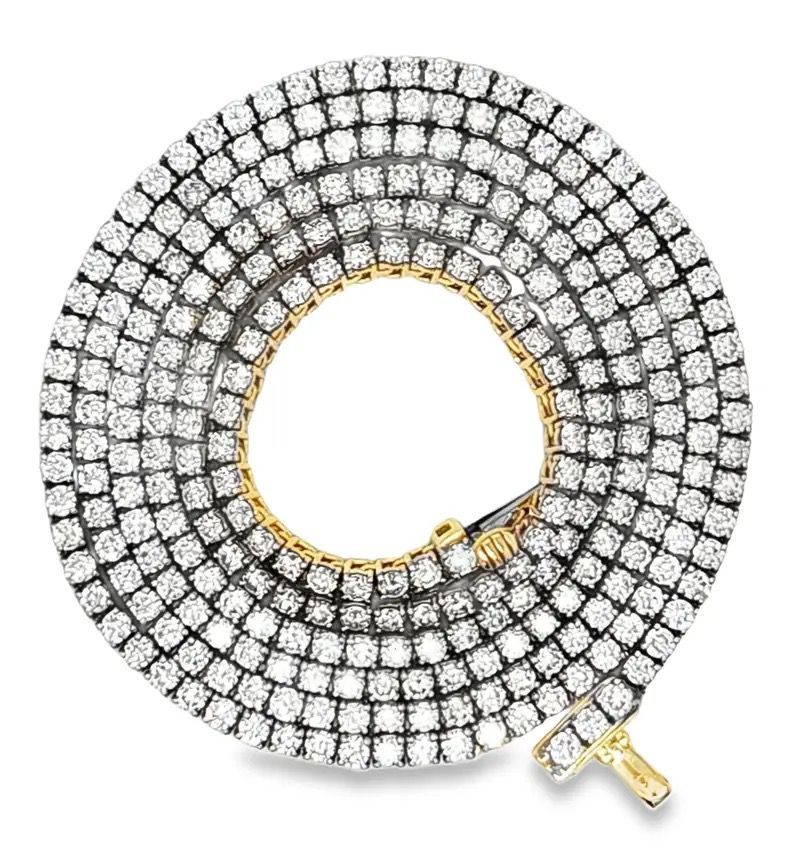 Gold and diamond circular pendant with a large open center, isolated on white.