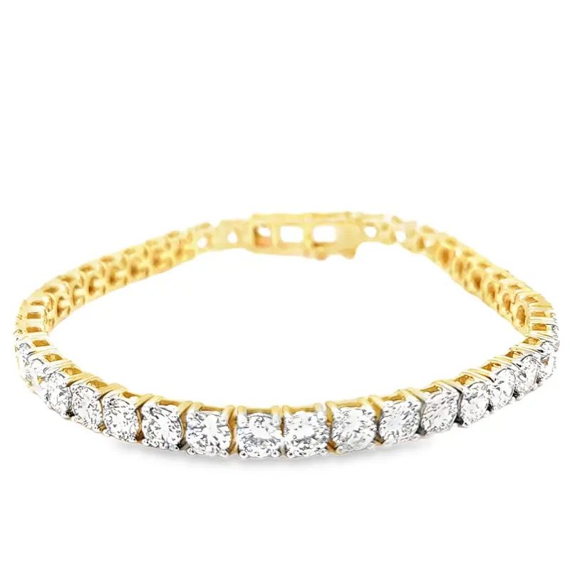 Gold and silver diamond tennis bracelet on a white background