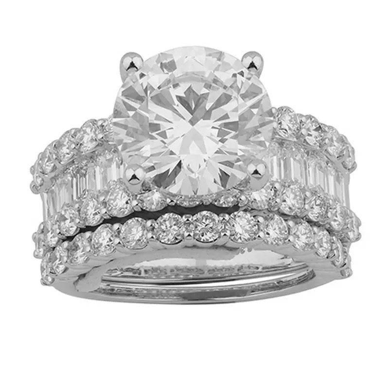 Diamond engagement ring set with a large round center stone and pavé halo on a silver band