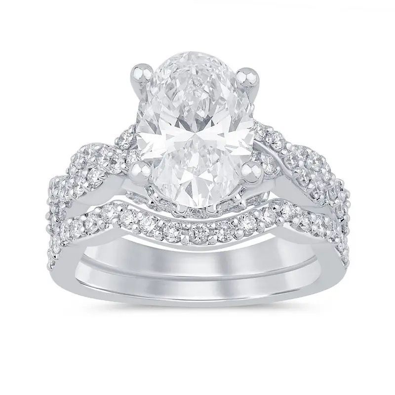 Two silver diamond-studded rings with a large central oval gemstone on a white background