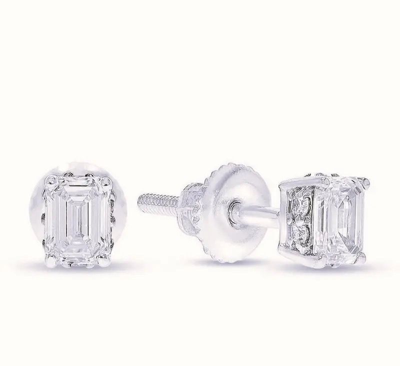 Pair of clear diamond stud earrings on a white background, shown from front and side.