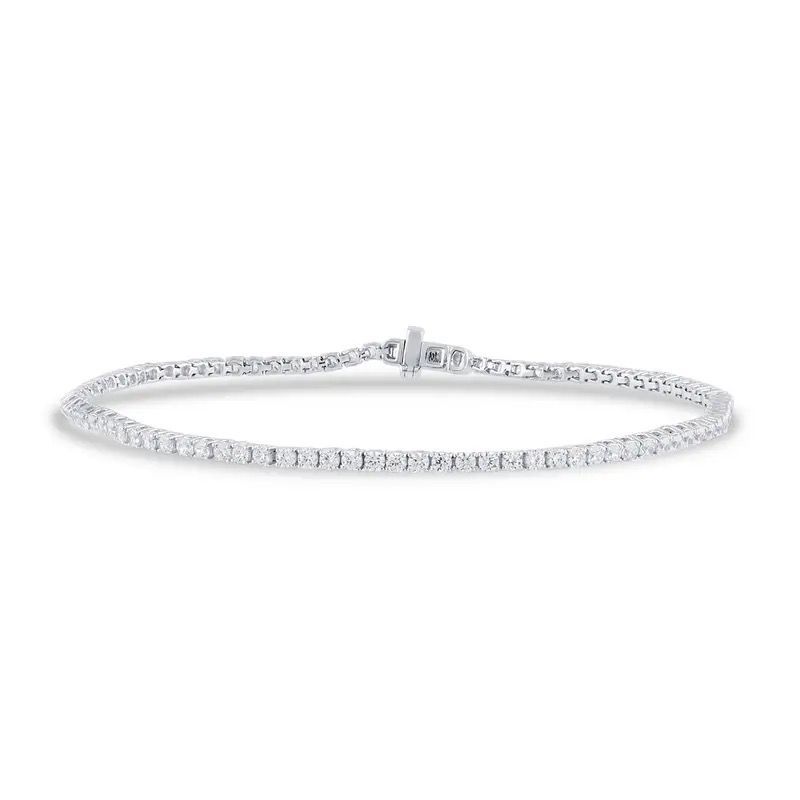 Silver tennis bracelet with a clasp, laid flat on a white background