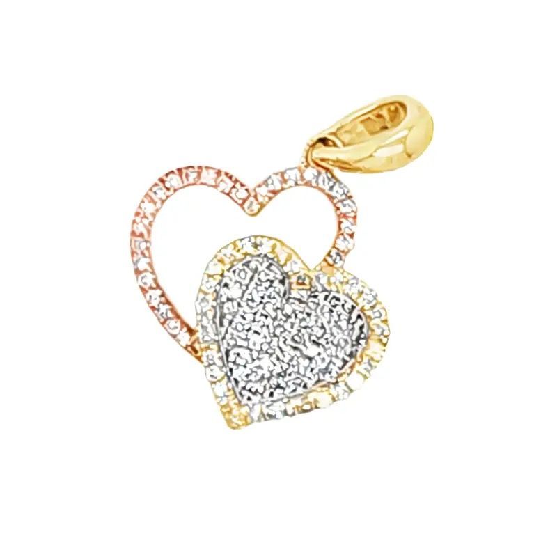 Two interlocking heart-shaped gold and silver pendant charms with sparkling stones