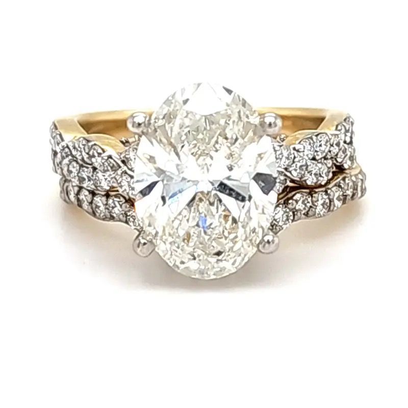 Oval diamond engagement ring with gold band and side diamond accents