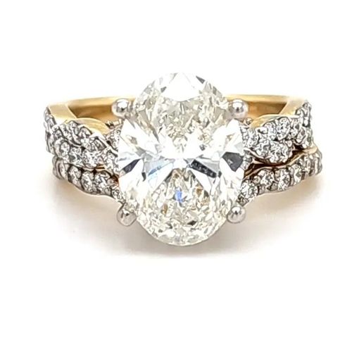 Oval diamond engagement ring with gold band and side diamond accents